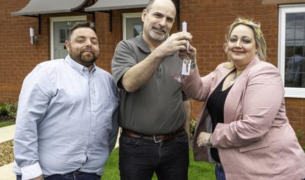 A couple of tenants receiving the key to their new home