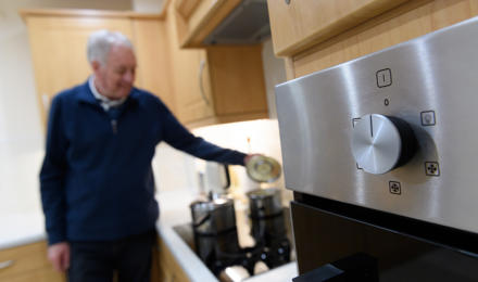 A tenant cooking in their kitchen