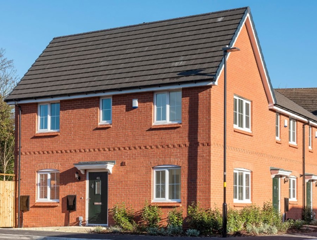 A newly built house on the corner in the sunshine