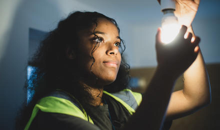 A repairs operative changing a light bulb