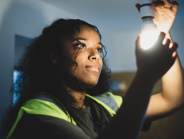 A repairs operative changing a light bulb