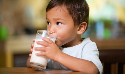 A child drinking a glass of milk