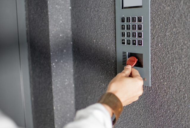 A tenant using their fob to enter an apartment block