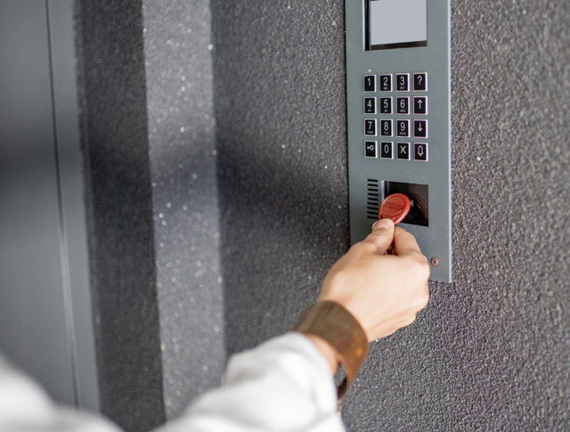 A tenant using their fob to enter an apartment block