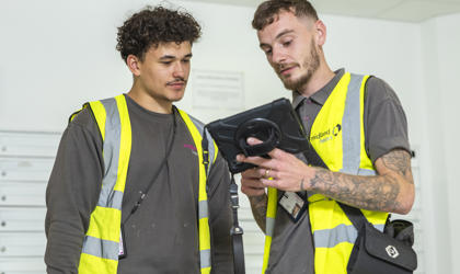 2 repairs operatives looking at a tablet