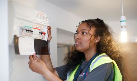 Repairs operative looking at a fuse box